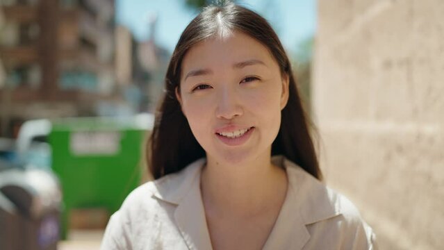 Chinese woman smiling confident standing at street