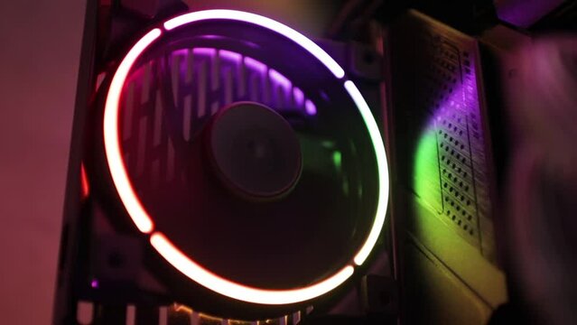 Rgb fan in pc case. Rainbow propeller for cooling computer components.