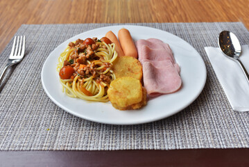 Mix food ham, sausage, potatp fried and spaghetti with tomato sauce in the one dish.  Is very nice  breakfast.
