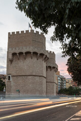 Fototapeta na wymiar Side view of the Torres de Serrano in Valencia, Spain. To become night
