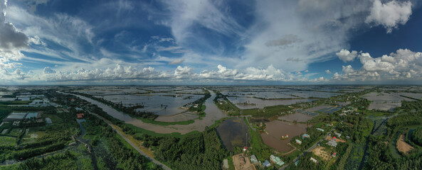Aerial panorama view of colorful Mekong Delta afternoon over water agricultural land and canals in Vietnam.