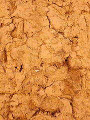 An old clay wall. Abstract textured background of red color.