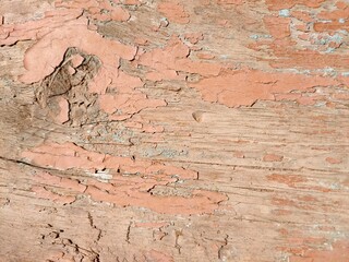 Peeling paint on the board. Old wooden textured background with paint.