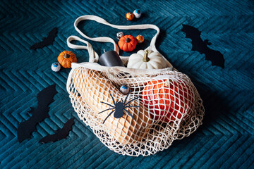 Sustainable Halloween. Eco-Friendly Halloween, plastic free trick-or-treating, Green Halloween. Zero waste Halloween decoration pumpkins, paper bats and spiders, candy in zero waste reusable bag