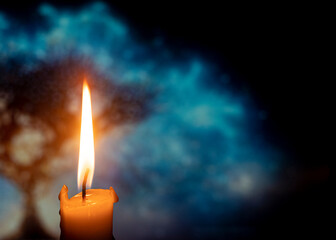 burning candle on bokeh background, blurred background
