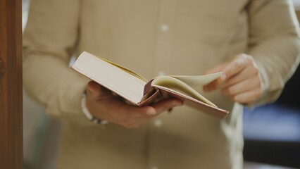 Man holding and reading book.