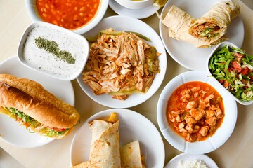 Table scene of assorted take out or delivery foods. Traditional Turkish cuisine. Various Turkish meal and appetizers. Top down view on a table.