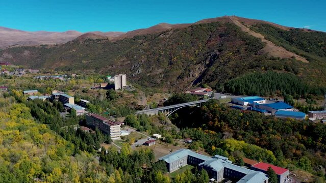  Aerial footage Armenian mountain city Jermuk, Caucasus. Aerial view Jermuk mineral water resort town in Armenia, western Asia. mountain spa town in southern Armenia. Popular touristic place.
