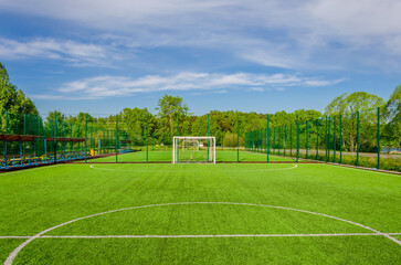 Obraz premium A football field in the forest in summer.