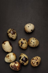 Quail eggs on black background. Healthy food concept. Top view