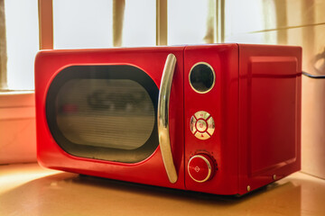 a red microwave in a kitchen
