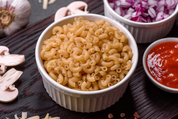 Raw pasta, mushrooms, onions, mince, spices and herbs to make a delicious paste