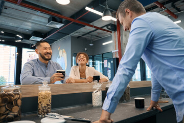 Corporate worker and his coworkers enjoying coffee break