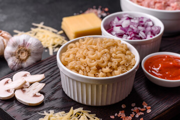 Raw pasta, mushrooms, onions, mince, spices and herbs to make a delicious paste