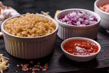 Raw pasta, mushrooms, onions, mince, spices and herbs to make a delicious paste