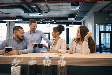 Young company employees enjoying their coffee break