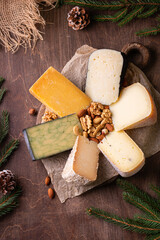 Fototapeta premium various types of cheese with nuts on rustic wooden table