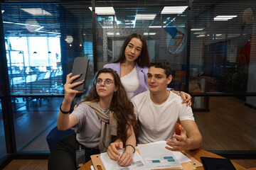 Man and two women are capturing their time on camera