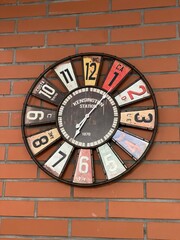 wall watches with funky dial on red brick wall