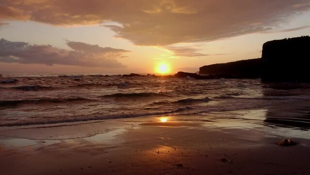 Sunrise in Galician beach whit waves