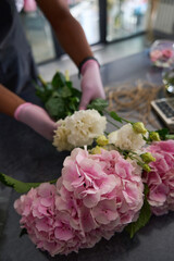 Male hands in pink gloves hold flowers