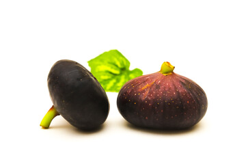 Dark figs on a white background. Shallow depth of field