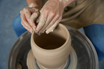 Close-up of a potter hand in the process of work