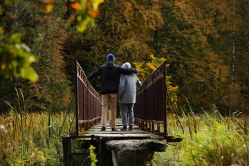 Young adult son and mother on a narrow bridge. Pavel Kubarkov, i and my Mother Marina and autumn nature around us. Photo was taken 20 September 2022 year, MSK time in Russia. - 533033050