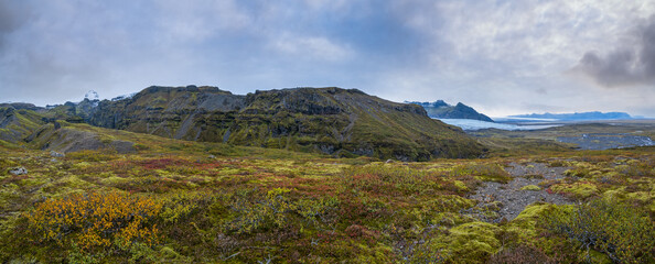 Beautiful autumn view from Mulagljufur Canyon to Fjallsarlon glacier with Breidarlon ice lagoon, Iceland. Not far from Ring Road and at the south end of Vatnajokull icecap and Oraefajokull volcano.