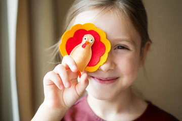 craft for kids. DIY felt Turkey for thanksgiving day. create art for children. girl playing with...