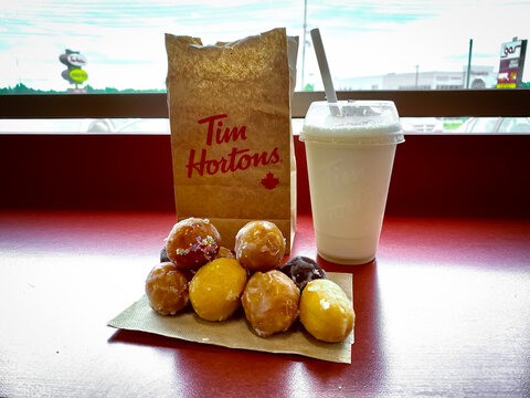 Tim Hortons bag of Timbits doughnut holes and milkshake. Tim Hortons Inc., commonly nicknamed Tim's or Timmies, is a Canadian multinational fast food restaurant chain.