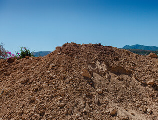Heap of the earth with a blue sky.  Dried earth.