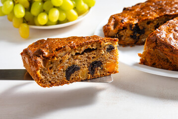 Homemade carrot cake on white wooden table
