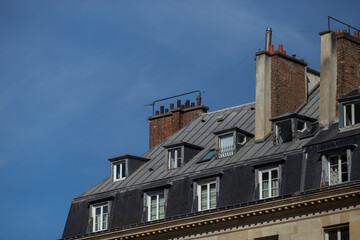 Fototapeta na wymiar Roofs of a house in Paris close-up on a sunny day.