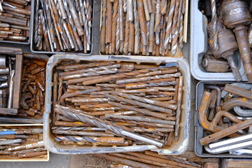 close-up showcasing old rusty metal and brass parts in bulk for decoration or collection, sold at a...