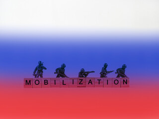 Fototapeta na wymiar The word mobilization and soldiers on a light background. Mobilization in Russia.