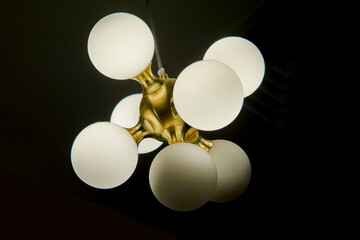 Ceiling chandelier with LED lamps on a dark background
