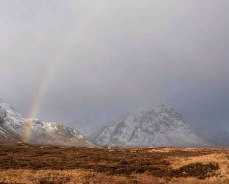 Majestic landscape image of vibrant rainbow in front of mountains in Scottish Highlands Rannoch Moor Stob Dearg