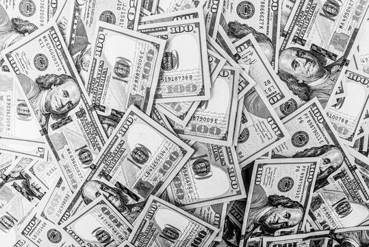 Black and white photo of 100 dollar bills. Money American currency as background.