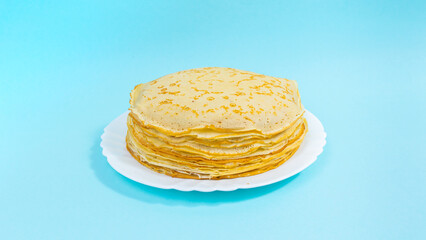 A stack of thin pancakes on a white plate. Minimalism. Copy space