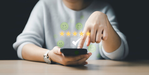 women choose five stars and have an iconic emotional smile floating around the mobile. Customer review satisfaction questionnaire feedback survey concept, User give a rating to the service experience.
