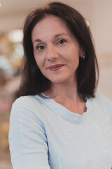 Portrait of a teacher in a preschool institution, in the background of the classrooms