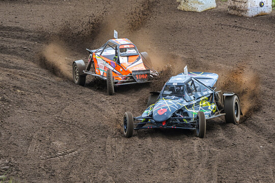 Grambek, Germany, September 10, 2022: Car racing Autocross ADAC NAX-Club Moelln, two special buggies on the race track on dirt and soil, copy space, selected focus, motion blur