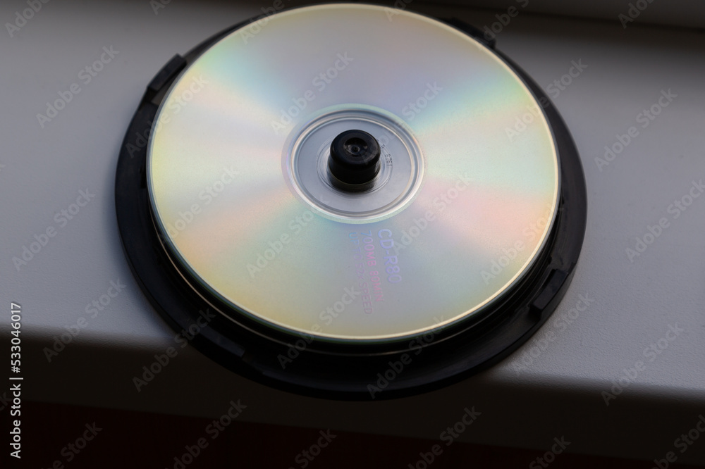 Fototapete cd on a white window sill in daylight. for data storage.