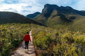 girl in red sweatshirt begins hike to highest peak in western australia, bluff knoll in stirling...