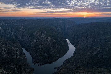 Amazing natural landscape with a panoramic view of the Douro River at sunset. From the Fraga do Puio viewpoint in the north of Portugal we can see the water running between the cliffs 