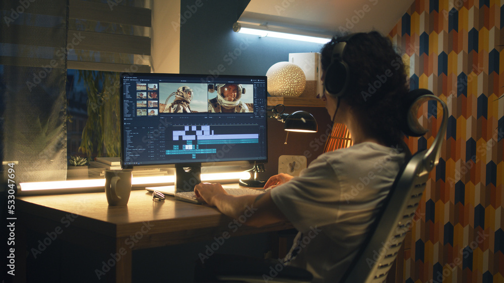 Poster guy in headphones editing video with astronauts for space blog in professional program while working