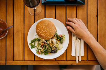 zenithal view of a hamburger with salad