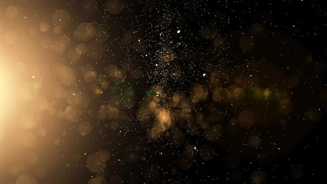Gold particles falling on black background in Slow Motion Animation. Shiny Christmas golden lights 4K.