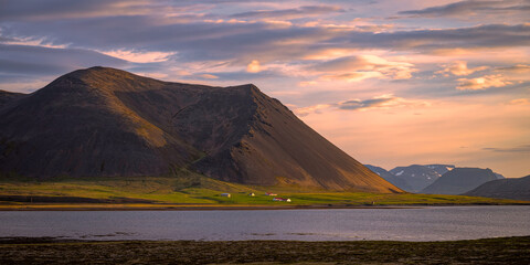 Mountainous landscape in Iceland at sunset with a lake in the foreground